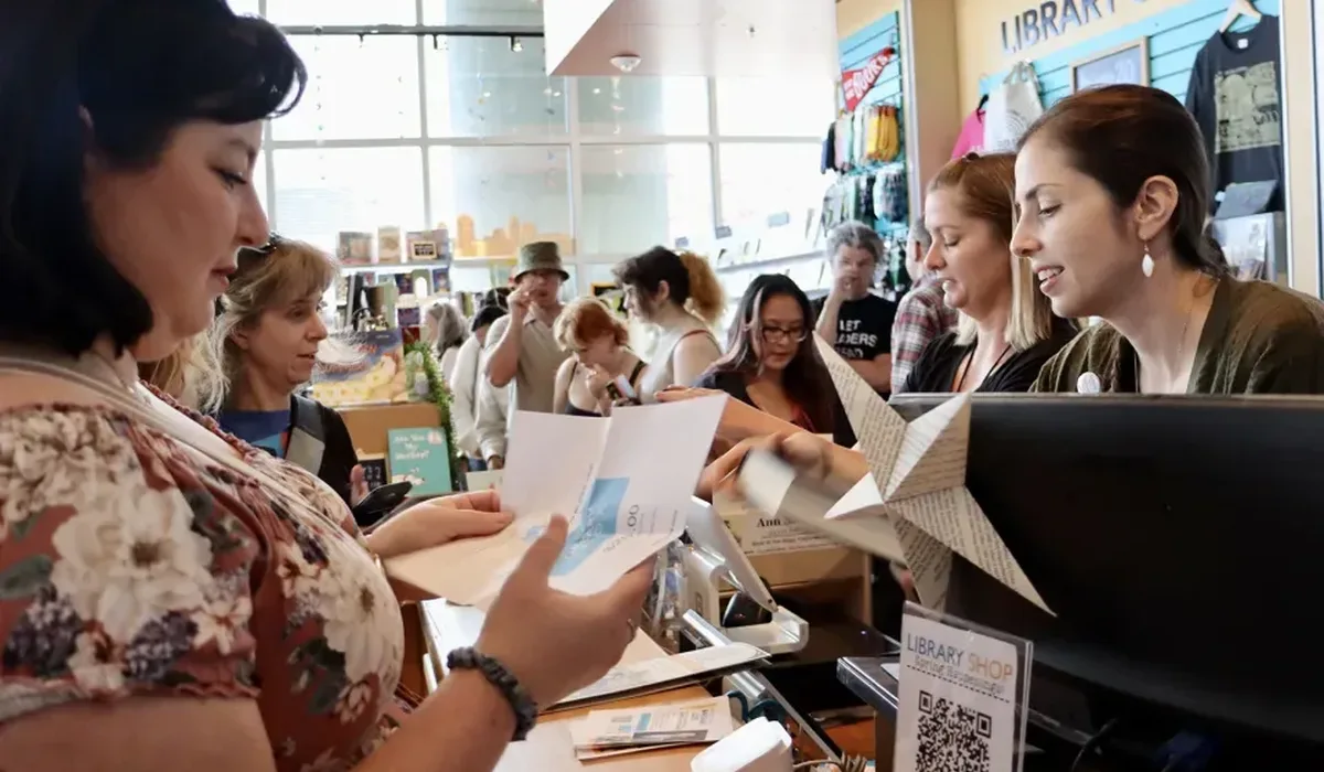 Customers line up to buy books in the Library Shop at the San Diego Central Library during the 2025 San Diego Book Crawl. (Library Foundation SD)