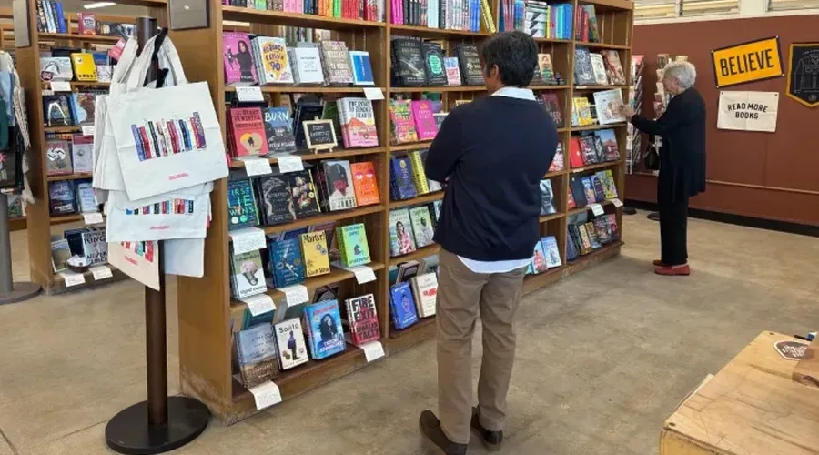 A guest perusing the shelves at the new bookstore. (Photo courtesy of Library Foundation SD)