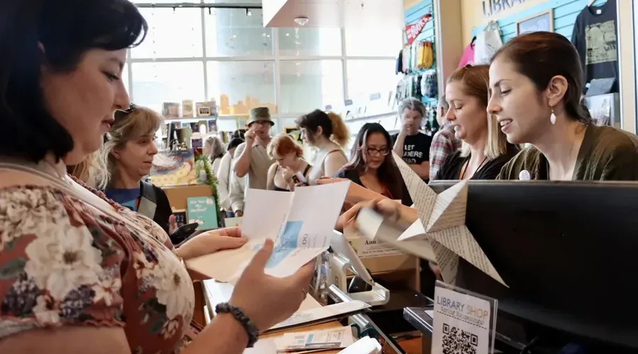 Customers line up to buy books in the Library Shop at the San Diego Central Library during the 2025 San Diego Book Crawl. (Library Foundation SD)