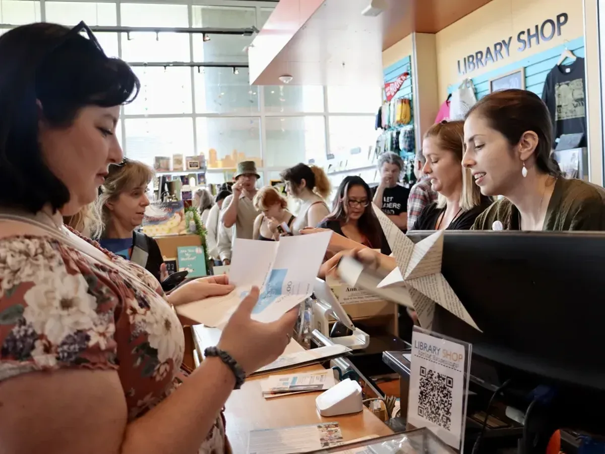 Customers line up to buy books in the Library Shop at the San Diego Central Library during the 2025 San Diego Book Crawl. (Library Foundation SD)